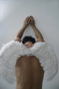 77280392-man-wearing-angel-wings.webp