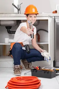 woman-showing-wrench-camera-74303481.webp