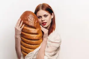 woman-holding-a-large-loaf-and-bright-makeup-in-her-hands-light-clothing-model_163305-69022.webp