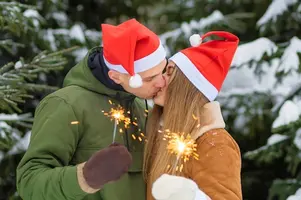 couple-love-christmas-new-year-guy-girl-hugging-lighting-sparklers-kissing-winter-holiday-fro...webp